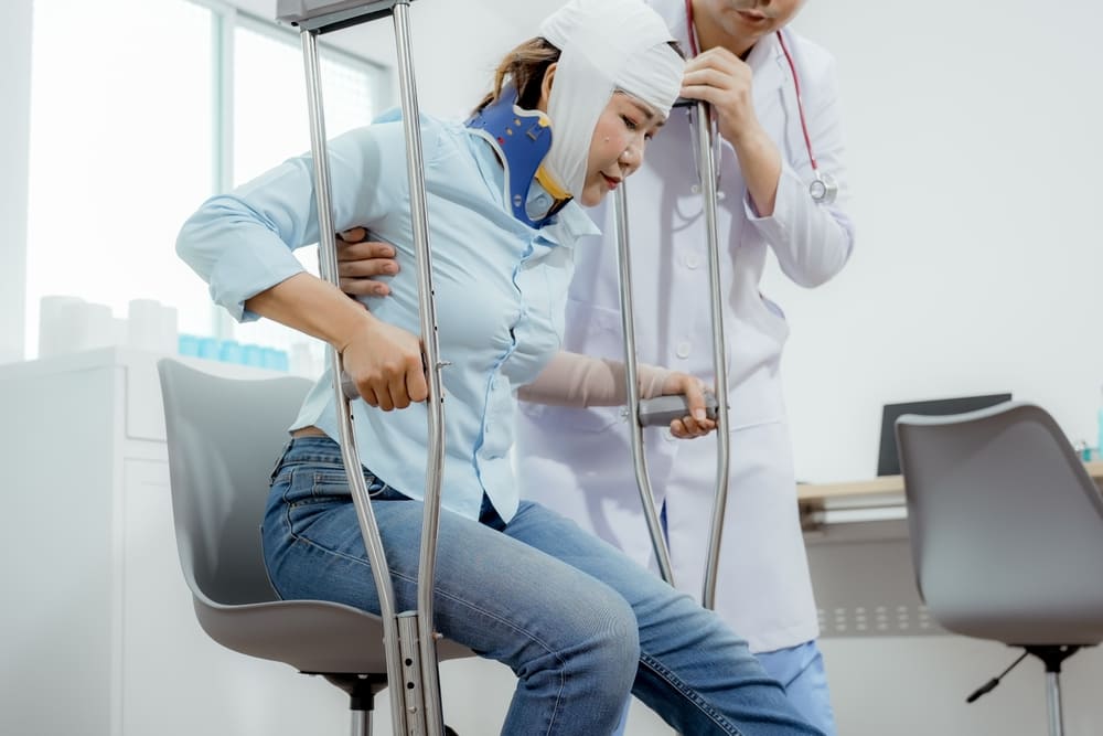 Caregiver assisting patient through NHTD Programs for traumatic brain injuries