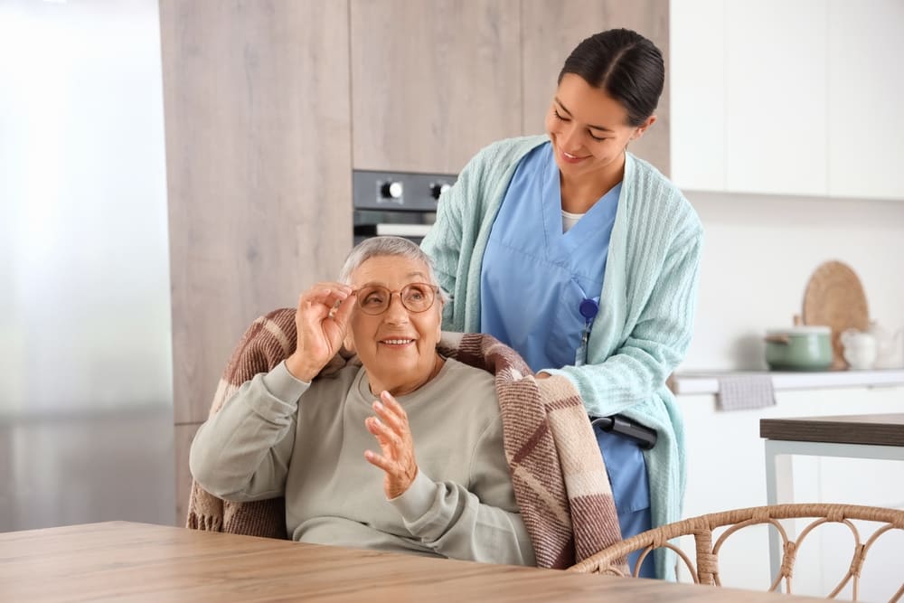 Home Health Aide assisting an elderly patient at home